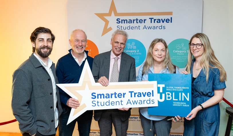 two blonde women, a dark haired man, and two grey haired men receiving a smarter travel student award