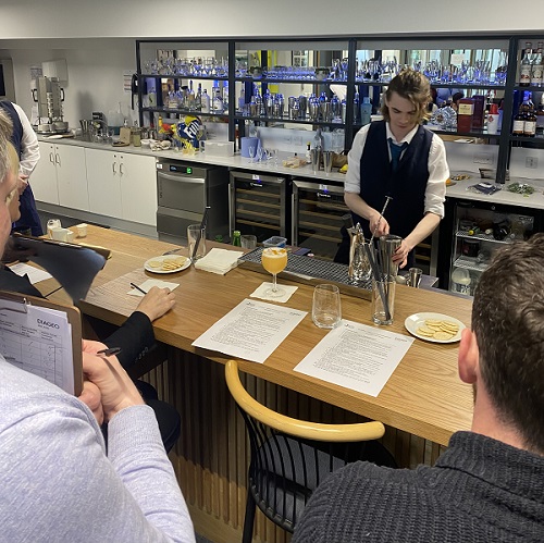 Student Samuel Lynch preparing the winning cocktail