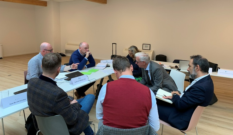 Group of academics in discussion at a table