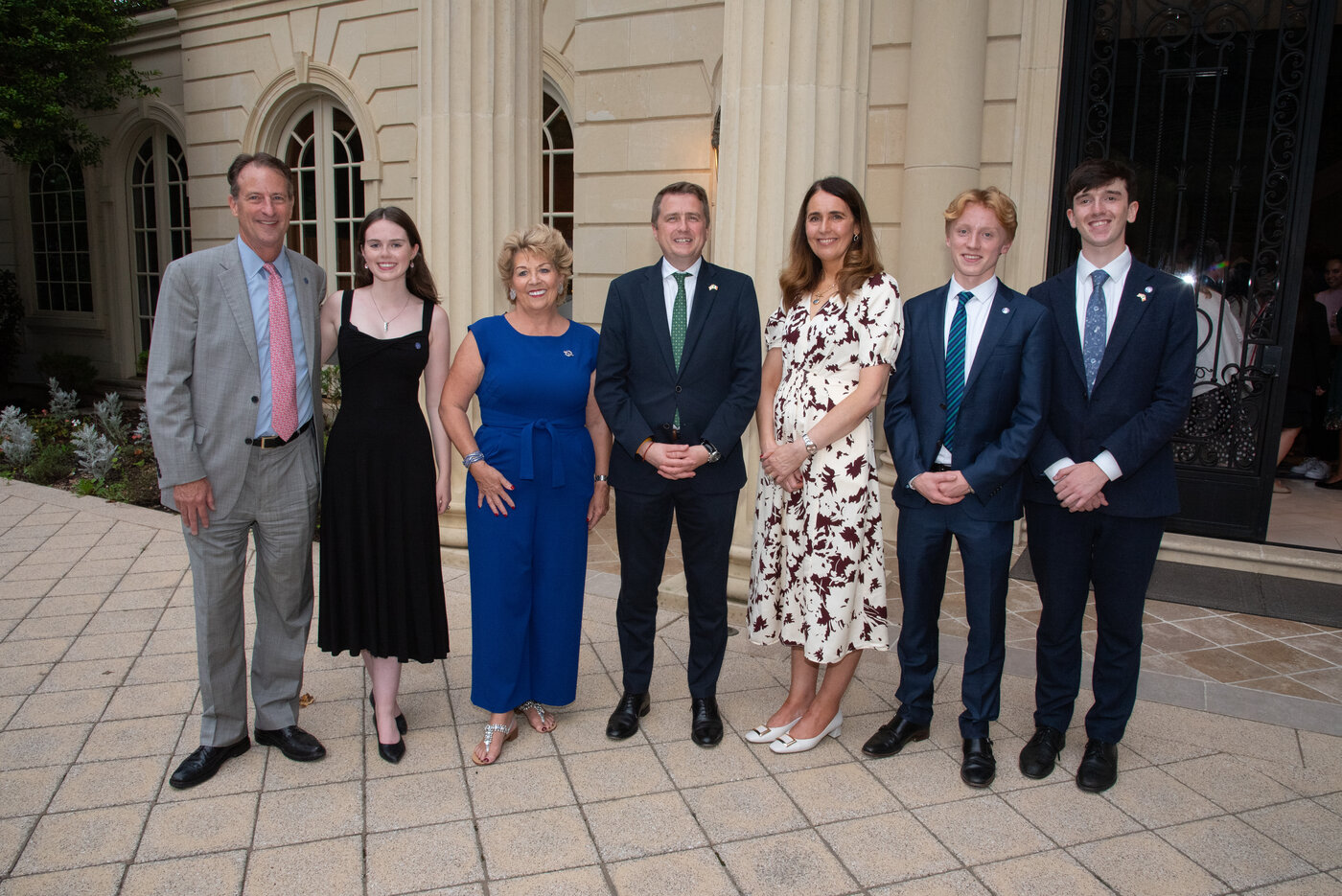 An image of a seven people (male and female) standing in front of a buidling