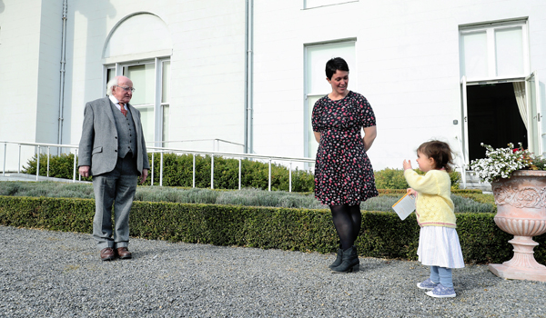 President Higgins playing with a child