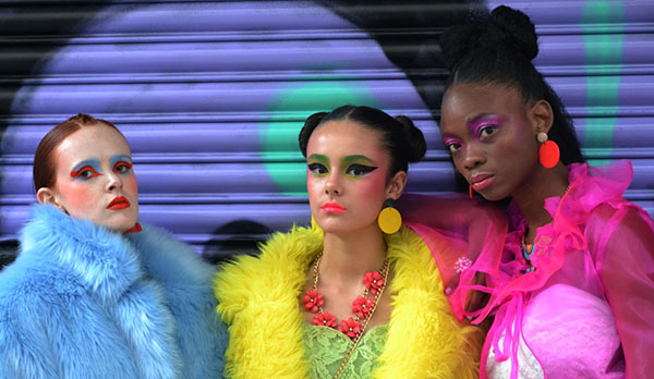 Image of three fashionable, cool women wearing bright clothing