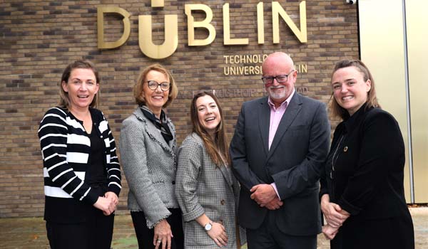 A group of people in front of a TU Dublin logo