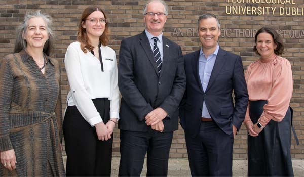 A group standing in front of the TU Dublin logo