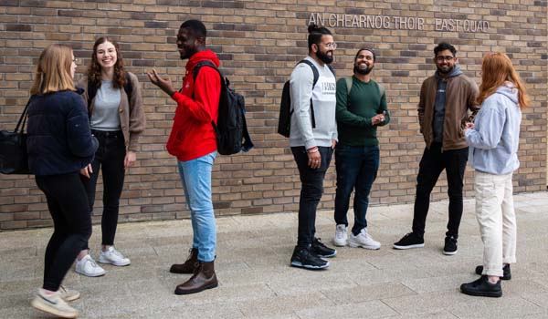 Students beside a TU Dublin logo