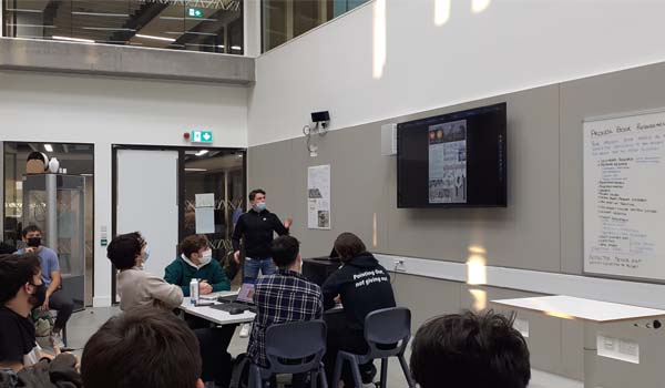 A lecturer talking to  group of students