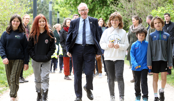 Children walk with man in the park