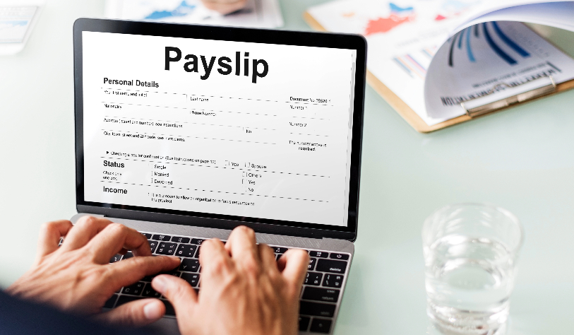 laptop with payslip