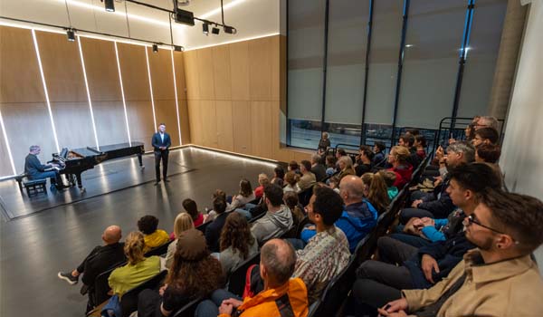 An audience watches a performance in the Recital Hall in the East Quad