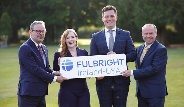 Four people holding a sign that says Fulbright Ireland USA