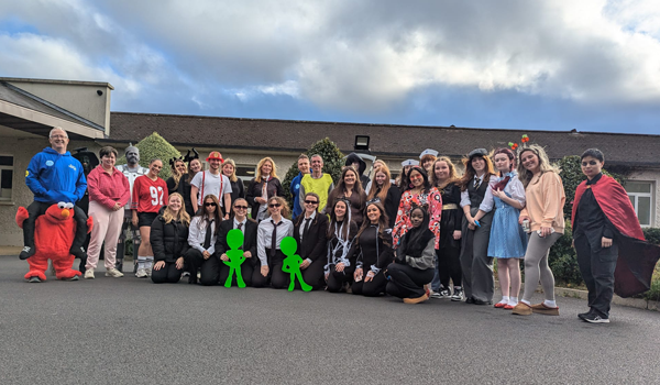 A group photo of people in costume for Halloween