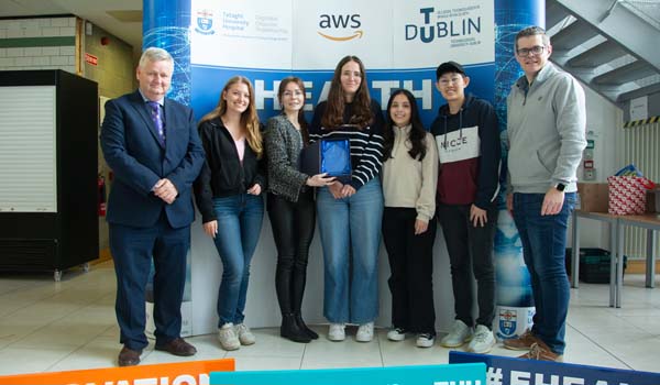 Pictured from left to right Barry Feeney, Head of School of School of Enterprise Computing & Digital Transformation;  Cloë van Geest; Joanne Reynolds, Community Engagement Manager AWS; Marta de la Cuadra Lozano; Valentina Duque Leiva; Wan Yit Yong and John Kelly, Deputy CEO of TUH