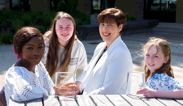 A group of young, smiling people with Minister for Education Norma Foley