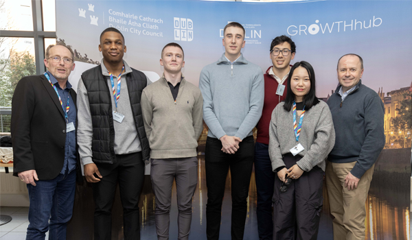 Group of people standing in front of a banner