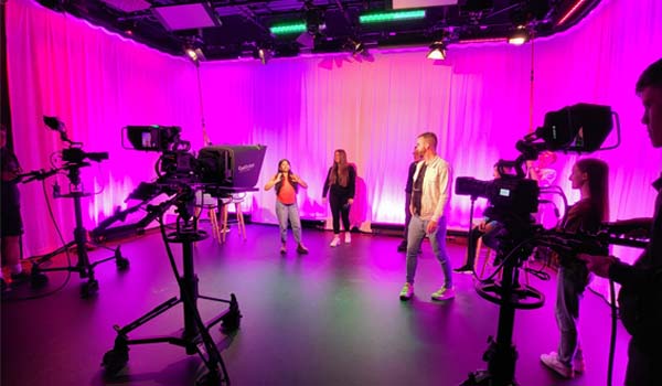 Secondary school students working with TU Dublin staff and students in a TV studio in the East Quad