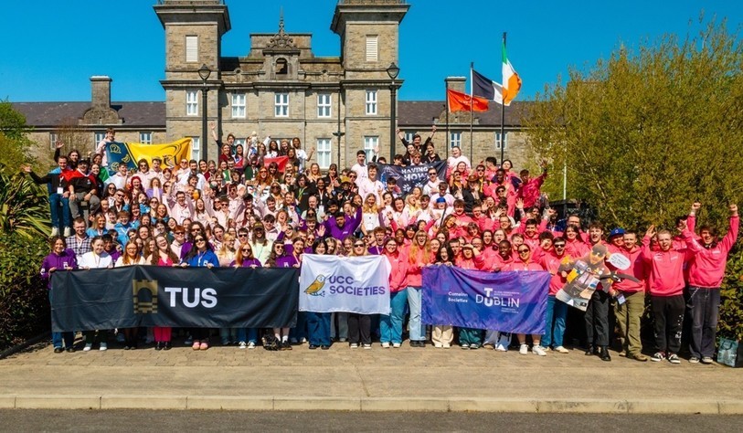 A group of people cheering and waving flags