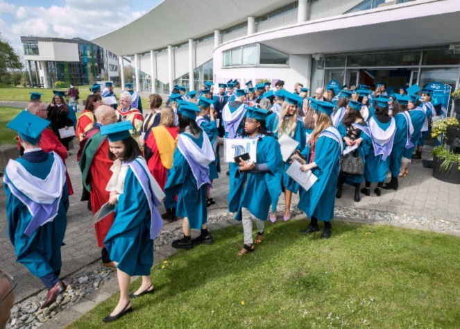 Graduates outside building