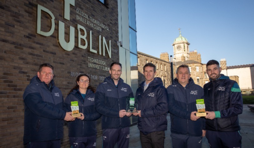 Sports Staff with Awards outside East Quad